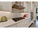 This kitchen has an oven, range hood, gas cooktop and light gray backsplash at 221 Thompson St, Alpharetta, GA 30009