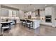 Modern white kitchen with stainless steel appliances, large island, and sleek bar stools perfect for entertaining at 221 Thompson St, Alpharetta, GA 30009