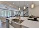 This kitchen has stainless steel sinks, marble countertops, and pendant lights hanging from the ceiling at 221 Thompson St, Alpharetta, GA 30009