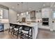 Contemporary white kitchen featuring a spacious island, stainless steel appliances, and stylish pendant lighting at 221 Thompson St, Alpharetta, GA 30009