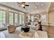 Bright open-plan living room with large windows, comfortable seating, and adjacent dining area for easy entertaining at 221 Thompson St, Alpharetta, GA 30009