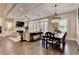 Bright open-plan living room with coffered ceiling, fireplace, and dining area showcasing modern design and hardwood floors at 221 Thompson St, Alpharetta, GA 30009