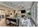 Spacious living room with stone fireplace, large windows, and open layout connecting to a modern white kitchen at 221 Thompson St, Alpharetta, GA 30009
