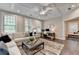 Inviting living room featuring a stylish ceiling fan, abundant natural light, and a cozy seating area, ideal for relaxation at 221 Thompson St, Alpharetta, GA 30009