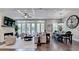 This living room has a ceiling fan, fireplace, French doors, and a decorative wall clock at 221 Thompson St, Alpharetta, GA 30009