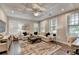 Spacious living room boasts coffered ceilings, ample natural light, and comfortable seating, perfect for relaxation and entertaining at 221 Thompson St, Alpharetta, GA 30009
