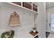 A mudroom with coat rack, seating bench and cubbies offers an organized entry at 221 Thompson St, Alpharetta, GA 30009