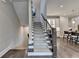 Elegant staircase with carpeted steps and decorative railings, seamlessly connecting the different levels of the home at 221 Thompson St, Alpharetta, GA 30009