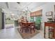 Charming dining area features a round table, built-in bench, and stylish chandelier, adjacent to the modern kitchen at 4442 Mclain Cir, Acworth, GA 30101