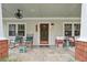 Inviting covered front porch with tiled floors, comfortable seating, and ceiling fan at 4442 Mclain Cir, Acworth, GA 30101