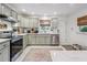 Bright kitchen features updated appliances, marble countertops and a breakfast bar, creating a seamless cooking space at 4442 Mclain Cir, Acworth, GA 30101