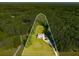 Aerial image of property boundaries showcasing this home's enviable position on a green lot enveloped by dense woods at 692 Brooks Woolsey Rd, Brooks, GA 30205
