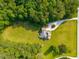 Overhead view of a beautiful home with a swimming pool and expansive green surroundings at 692 Brooks Woolsey Rd, Brooks, GA 30205