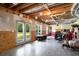 Unfinished basement with exposed beams, double doors to the exterior, and ample space at 692 Brooks Woolsey Rd, Brooks, GA 30205