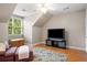 Bright bedroom with a window view, light-colored walls, and a stylish rug at 692 Brooks Woolsey Rd, Brooks, GA 30205