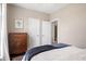 Bedroom featuring a decorative dresser, hardwood floors, and a view to the bathroom at 692 Brooks Woolsey Rd, Brooks, GA 30205