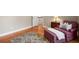 Comfortable bedroom setting with a plush chair, decorative pillows, and hardwood floors at 692 Brooks Woolsey Rd, Brooks, GA 30205