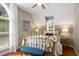 Comfortable bedroom with a large window, decorative iron bed, and hardwood floors at 692 Brooks Woolsey Rd, Brooks, GA 30205