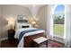 Inviting bedroom with a large arched window, decorative bedding, and hardwood floors at 692 Brooks Woolsey Rd, Brooks, GA 30205