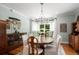 Formal dining room with chandelier, hardwood floors, built-in cabinet, and neutral paint at 692 Brooks Woolsey Rd, Brooks, GA 30205