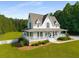 Stunning white home featuring a large, inviting porch and a well-maintained lawn at 692 Brooks Woolsey Rd, Brooks, GA 30205