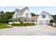 Inviting home exterior with a long porch, white siding, and a detached garage at 692 Brooks Woolsey Rd, Brooks, GA 30205