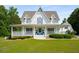 Charming home with a large porch, manicured landscaping, and a welcoming entrance at 692 Brooks Woolsey Rd, Brooks, GA 30205