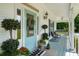 Welcoming front porch featuring potted plants, comfortable seating, and charming decor at 692 Brooks Woolsey Rd, Brooks, GA 30205