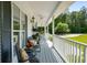 Relaxing front porch with comfortable seating, ceiling fans, and views of the landscaped yard at 692 Brooks Woolsey Rd, Brooks, GA 30205