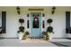 Inviting front porch with a 'Welcome to our porch' sign, potted plants, and charming decor at 692 Brooks Woolsey Rd, Brooks, GA 30205