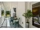 Cozy front porch featuring a small table set, potted plants, and views of the serene surroundings at 692 Brooks Woolsey Rd, Brooks, GA 30205