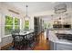 Open kitchen and breakfast nook with large windows and hardwood flooring, perfect for casual dining at 692 Brooks Woolsey Rd, Brooks, GA 30205