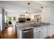 Modern kitchen featuring granite counters, stainless steel appliances, and open access to the living room at 692 Brooks Woolsey Rd, Brooks, GA 30205