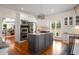 Kitchen boasts stainless steel appliances, granite countertops, and an island with a gas cooktop at 692 Brooks Woolsey Rd, Brooks, GA 30205