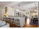 Bright, modern kitchen with stainless appliances, granite counters, breakfast bar, and adjacent dining area at 692 Brooks Woolsey Rd, Brooks, GA 30205