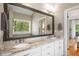 Main bathroom features double sinks with granite counters and a large mirror at 692 Brooks Woolsey Rd, Brooks, GA 30205