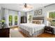 Inviting main bedroom featuring french doors, a cozy bed, and ample natural light at 692 Brooks Woolsey Rd, Brooks, GA 30205