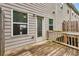 Back deck with wood flooring overlooks the yard and provides outdoor living space at 893 Society Sw Cir, Atlanta, GA 30331