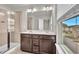 Bright bathroom features a double vanity, large mirror and a glass enclosed shower at 893 Society Sw Cir, Atlanta, GA 30331