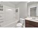 Bathroom with a shower-tub combo featuring chrome fixtures and storage shelves at 893 Society Sw Cir, Atlanta, GA 30331
