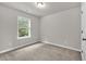 Bedroom with neutral walls and carpet with window view to trees outside at 893 Society Sw Cir, Atlanta, GA 30331