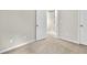 Neutral bedroom with carpeted floors, adjacent to a stairway and bathroom at 893 Society Sw Cir, Atlanta, GA 30331