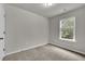 This bedroom features neutral walls, carpeted floors and a window view at 893 Society Sw Cir, Atlanta, GA 30331