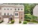 Charming townhome featuring a stone facade, attached garage, and well-maintained landscaping at 893 Society Sw Cir, Atlanta, GA 30331