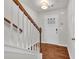 Entrance foyer featuring wood floors, white doors, and decorative staircase with wooden railing at 893 Society Sw Cir, Atlanta, GA 30331