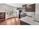 Modern kitchen with stainless steel appliances, granite countertops, and dark wood cabinets at 893 Society Sw Cir, Atlanta, GA 30331