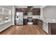 Bright kitchen featuring stainless steel appliances, granite counters, and rich hardwood flooring at 893 Society Sw Cir, Atlanta, GA 30331