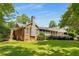 Sprawling backyard view with a large brick home and screened-in porch at 186 Mt Calvary Rd, Marietta, GA 30064