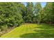Expansive, well-maintained backyard with mature trees and a wooden fence at 186 Mt Calvary Rd, Marietta, GA 30064