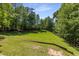 Large, open backyard with gentle slope and wood fencing, offering privacy at 186 Mt Calvary Rd, Marietta, GA 30064